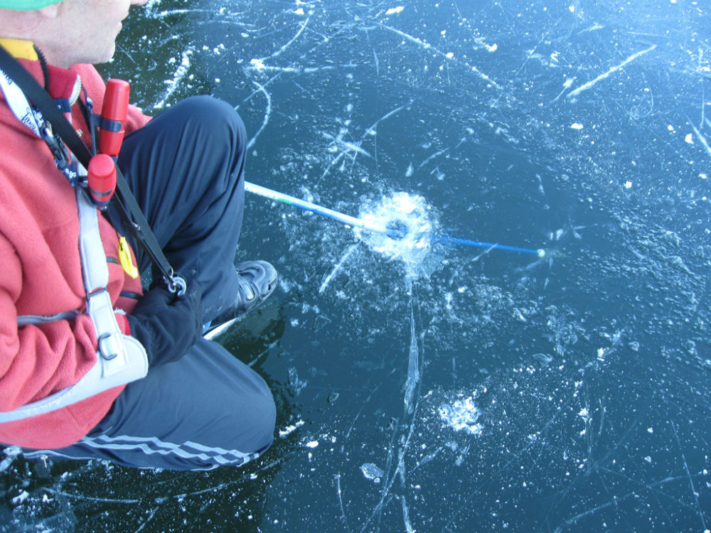 Dave Young poking a hole through the ice with his pole